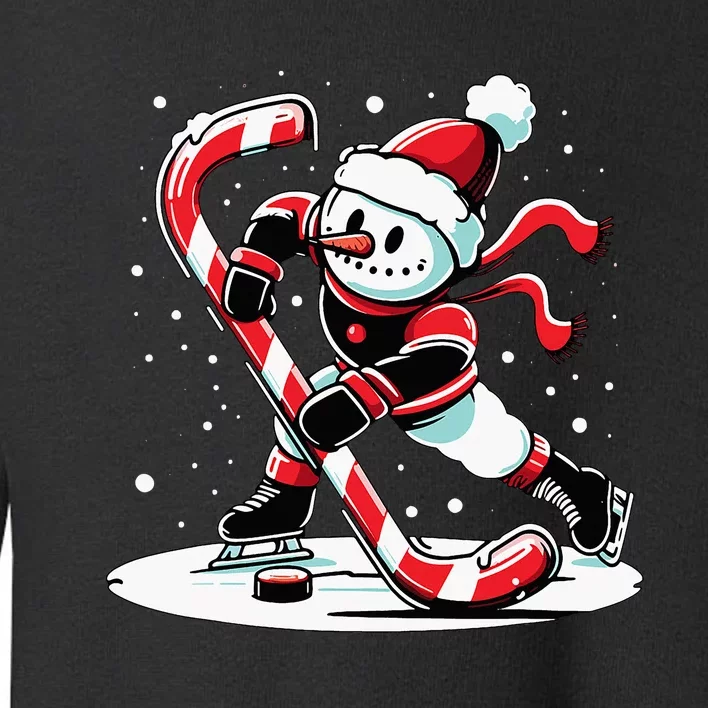 A snowman playing hockey with a candy cane hockey stick Toddler Sweatshirt