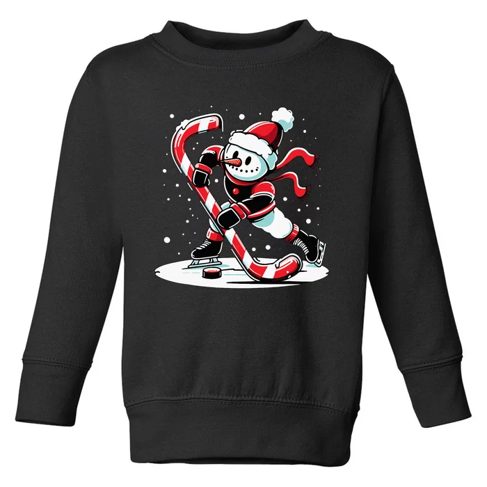 A snowman playing hockey with a candy cane hockey stick Toddler Sweatshirt