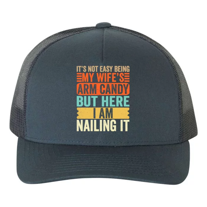 It's Not Easy Being My Wife's Arm Candy But Here I Am Nailin Yupoong Adult 5-Panel Trucker Hat