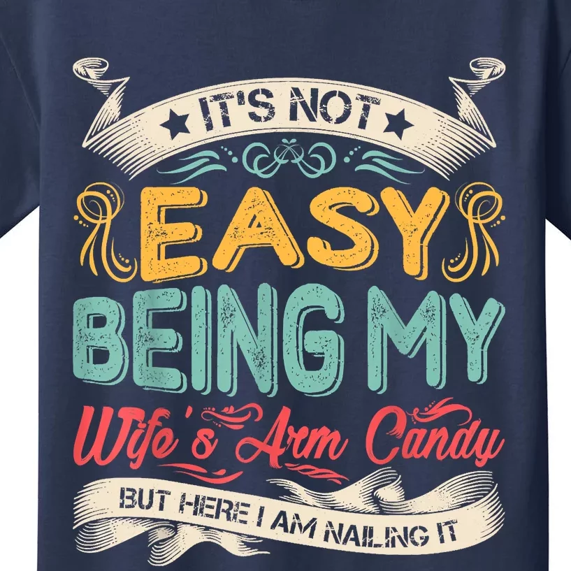 Its Not Easy Being My Wifes Arm Candy But Here I Am Nailin Kids T-Shirt