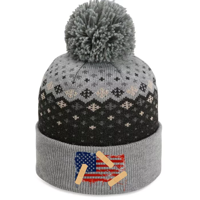 Patriotic Tattered American Flag With Bandages. The Baniff Cuffed Pom Beanie