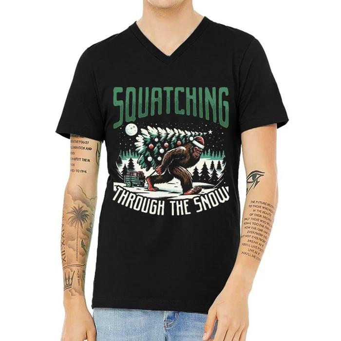 Squatching Through The Snow Bigfoot Carrying Christmas Tree V-Neck T-Shirt