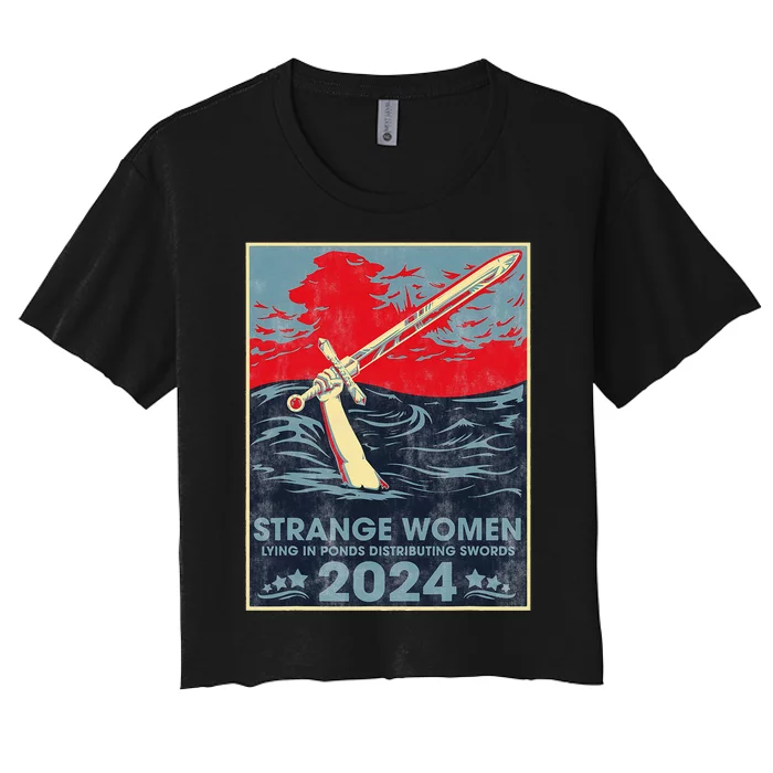 Strange Women Lying In Ponds Distributing Swords 2024 Women's Crop Top Tee