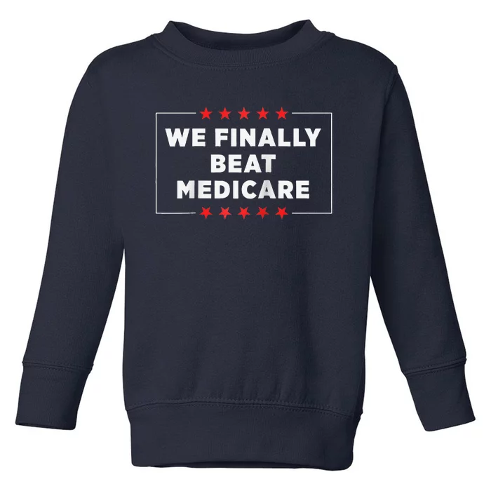 We Finally Beat Medicare Raglan Baseball Toddler Sweatshirt